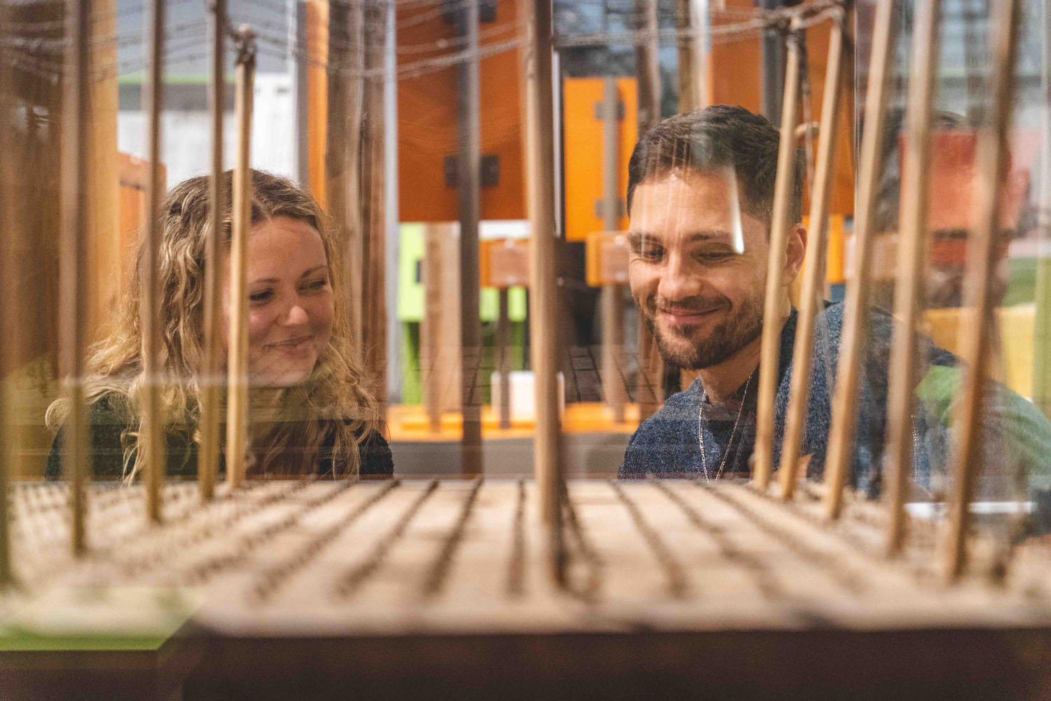 Two visitors study the model of a hop garden